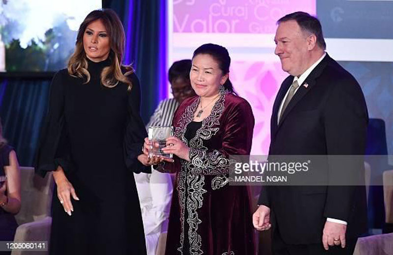 International Women of Courage (IWOC) Award recipient Sayragul Sauytbay of Kazakhstan poses with US Secretary of State Mike Pompeo (R) and First Lady Melania Trump at the State Department in Washington, DC on March 4, 2020. (Photo by MANDEL NGAN / AFP) (Photo by MANDEL NGAN/AFP via Getty Images)